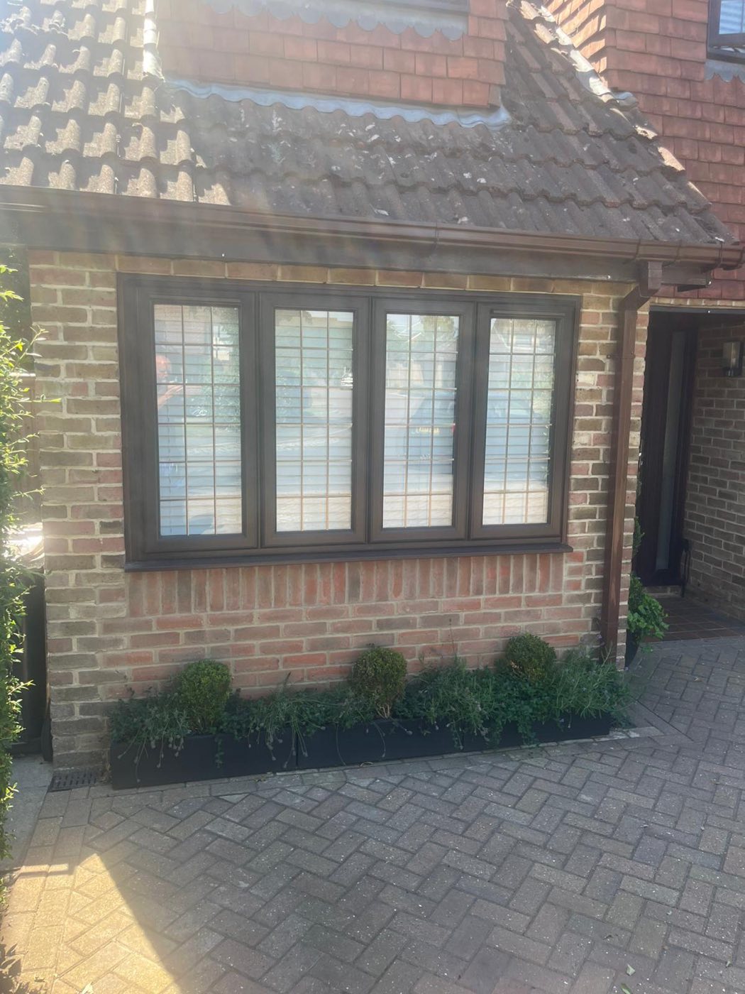 Close-up of the new hardwood-framed leaded window and matching brickwork