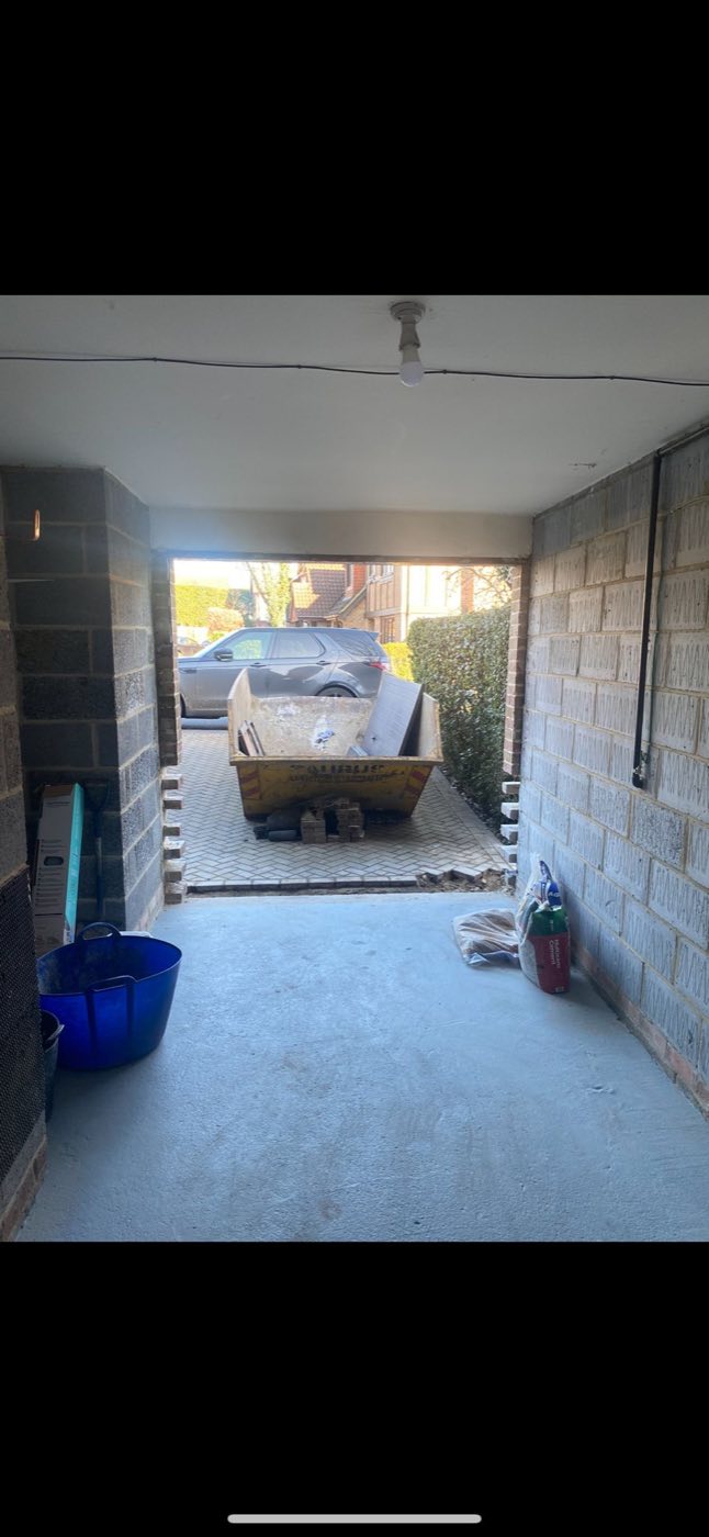 The garage interior during conversion, stripped back to blockwork with a new concrete floor