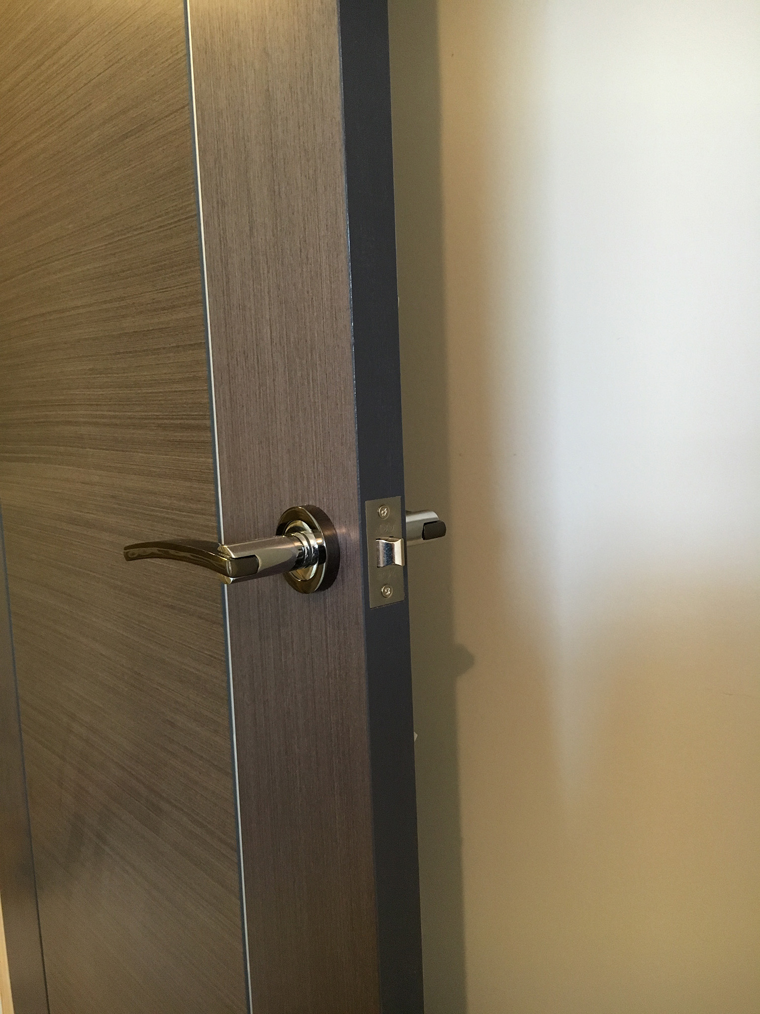 Close-up of veneered door grain and handle